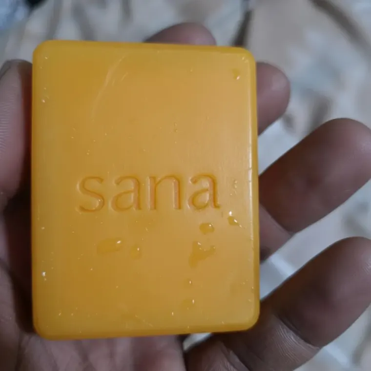 Customer holding the sana bar in her bathroom